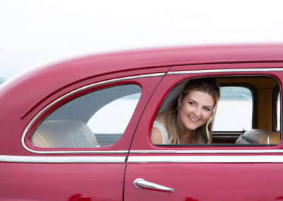 north wales bride looking through window of red car