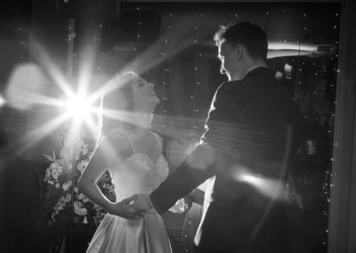 bride and groom dancing with a starburst of light in the backgrouns at Chester Racecourse