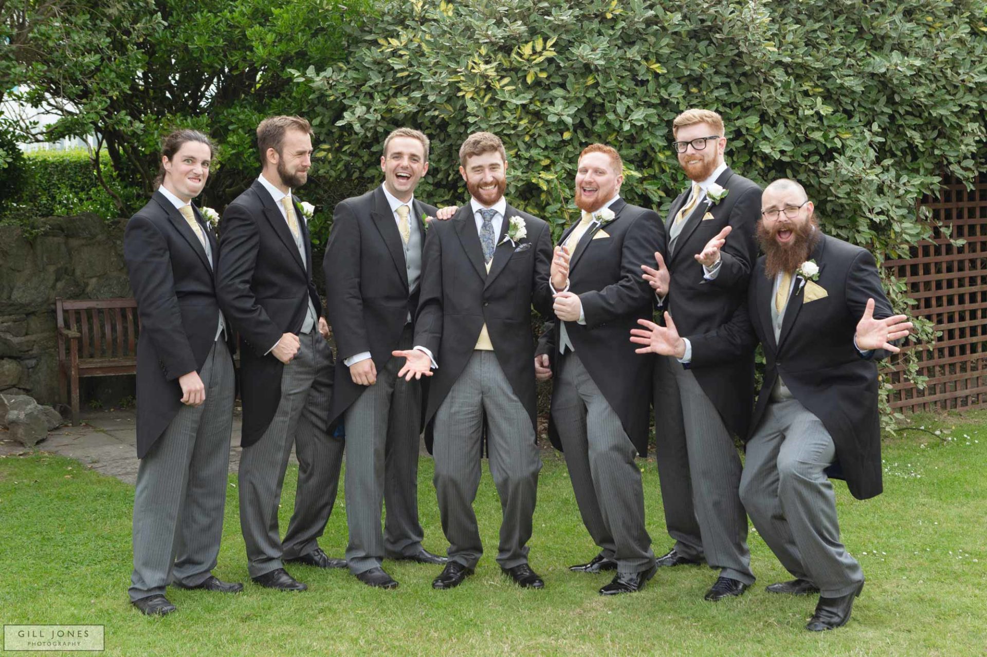 groomsmen posing for photographs in the grounds of the trearddur bay hotel