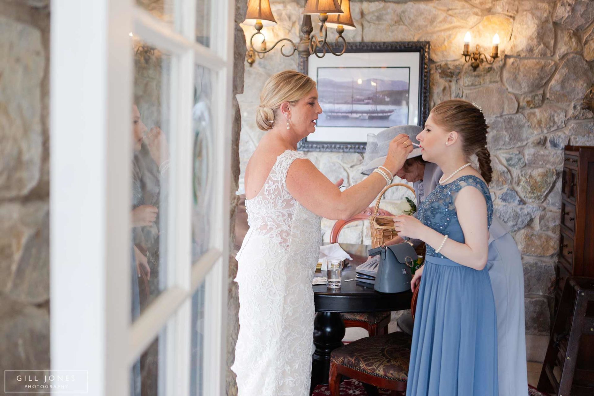 J&B__053 the bride's mum tieing her pearls on the bride