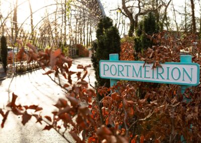 a sign stating Portmeirion surrounded by orange leaves by Anglesey wedding photographer Gill Jones Photography