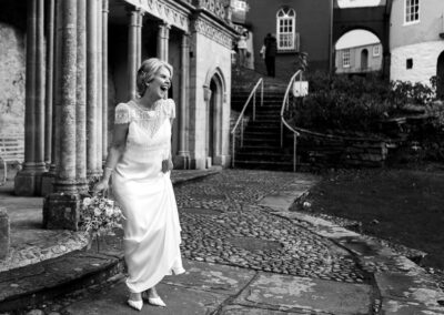 a bride laughs at someone not shown by Anglesey wedding photographer Gill Jones Photography
