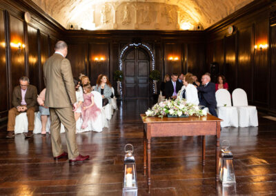 a groom waits for the doors of Hercules Hall to be opened so that he can see his bride by Anglesey wedding photographer Gill Jones Photography