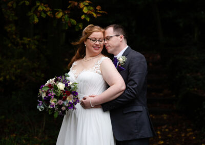 bride and groom caressing near Llyn Padarn lagoons