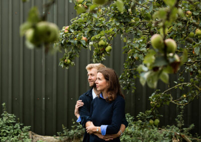 couple hugging in an orchard