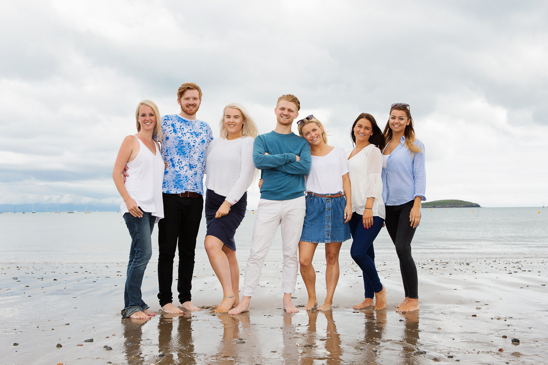 family standing together with the sea behind them at Abersoch