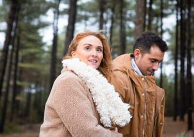 couple walking through Newborough forest by Anglesey wedding photographer Gill Jones