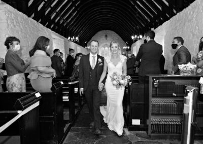 the bride and groom walking out of the churchat St. Mary's Church , Caerhun by Anglesey wedding photographer Gill Jones Photography