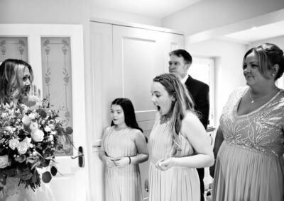 the bride's family see the bride for the first time in her wedding dress by Anglesey wedding photographer, North Wales, Gill Jones Photography