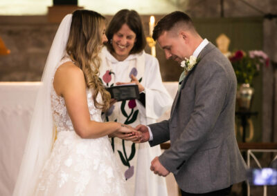 groom makes a fist as he finishes his wedding vows by Anglesey wedding photographer, North Wales, Gill Jones Photography