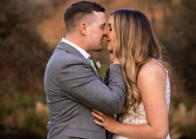 new husband and wife rub noses in an eskimo kiss by Anglesey wedding photographer, North Wales, Gill Jones Photography
