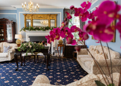 reception room at Plas Dinas with orchids in the foreground by Anglesey wedding photographer Gill Jones Photography