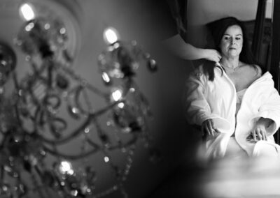 bride having her her done with chandelier twinkling by her side by Anglesey wedding photographer Gill Jones Photography