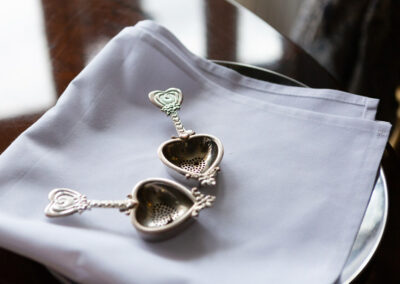 two heart shaped tea strainers on a napkin by Anglesey wedding photographer Gill Jones Photography