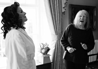 mother of the bride having a giggle by Anglesey wedding photographer Gill Jones Photography