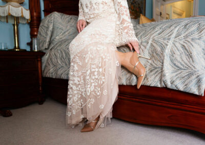 bride adjusting the strap on her shoe by Anglesey wedding photographer Gill Jones Photography