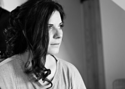 profile portrait of a bride as she has her hair curled by anglesey photographer Gill Jones Photography