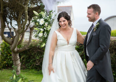 the bride and groom laugh together by Anglesey photographer Gill Jones Photography