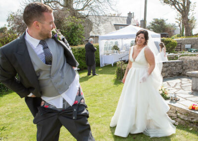 a groom shows his underpants showing pictures of his bride on them by Anglesey photographer Gill Jones Photography