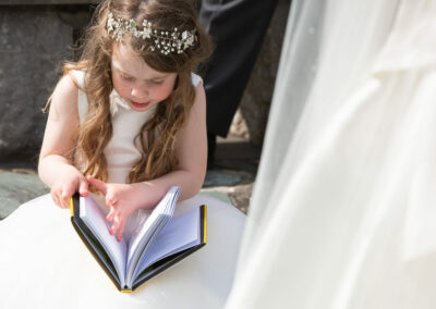 the bridesmaid flicks through a storybook by Anglesey photographer Gill Jones Photography