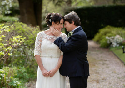 groom gently touching bride's jawline with the flat of his hand as she looks into his eyes by Anglesey wedding photographer Gill Jones Photography Anglesey wedding photographer Gill Jones Photography