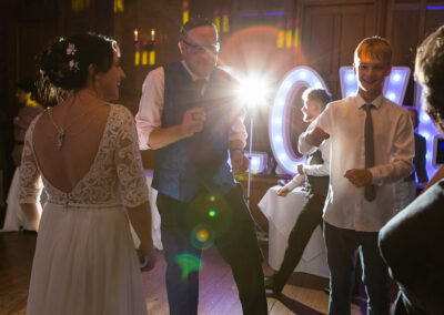 guests dancing to music on a dance floor by Anglesey wedding photographer Gill Jones Photography