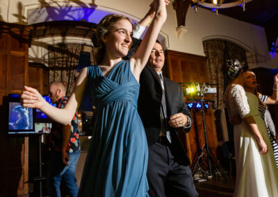 guests dancing to music on a dance floor by Anglesey wedding photographer Gill Jones Photography