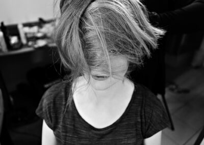 woman with her hair tousled across the front of her face by Anglesey photographer Gill Jones