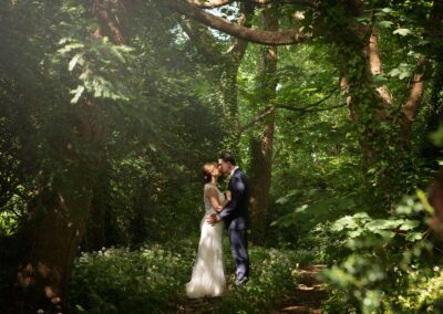 couple kissing in the woods by Anglesey wedding photographer Gill Jones