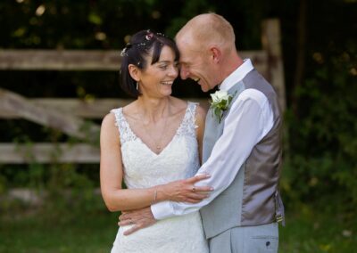 groom pressing his forehead against his new wife's head by Anglesey wedding photographer Gill Jones Photography