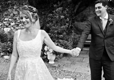 bride leading groom hand in hand by Anglesey wedding photographer Gill Jones